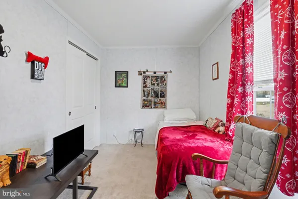 a bedroom with furniture and a flat screen tv