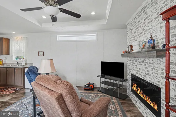 a living room with furniture a flat screen tv and a fireplace