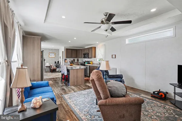 a living room with furniture and kitchen view