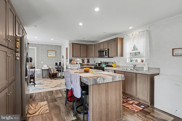 a kitchen with sink refrigerator and cabinets