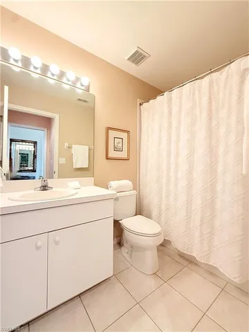 a bathroom with a toilet a sink and a mirror