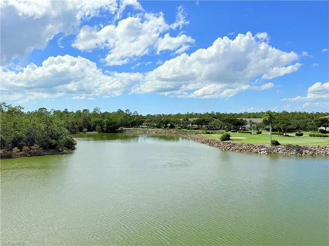 a view of a lake with houses in the back