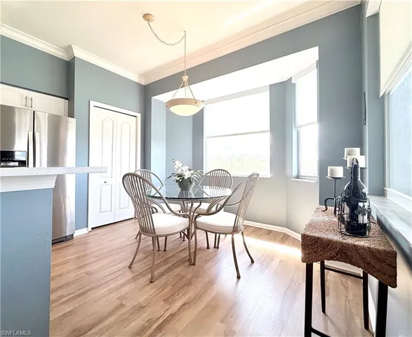 a view of a dining room with furniture and wooden floor