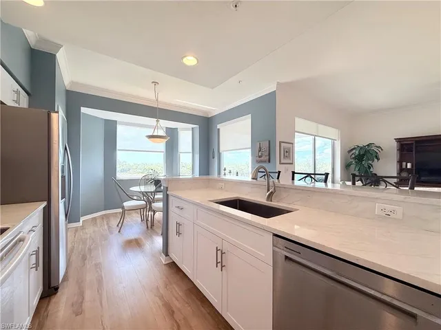 a kitchen with sink stove and refrigerator