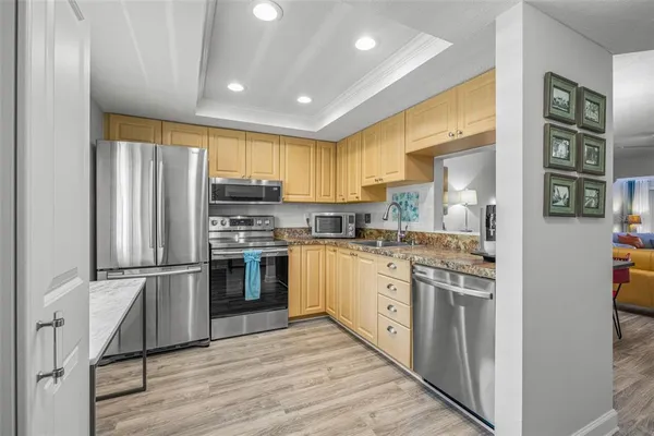 a kitchen with stainless steel appliances granite countertop a stove and cabinets