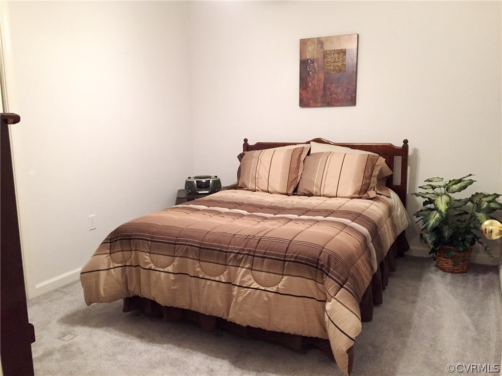 7317 Trailing Rock Road Prince George, VA 23875 - Photo 12 of 17 a bed sitting in a bedroom next to a small yard