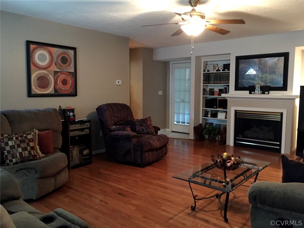 7317 Trailing Rock Road Prince George, VA 23875 - Photo 5 of 17 a living room with furniture a flat screen tv and a fireplace