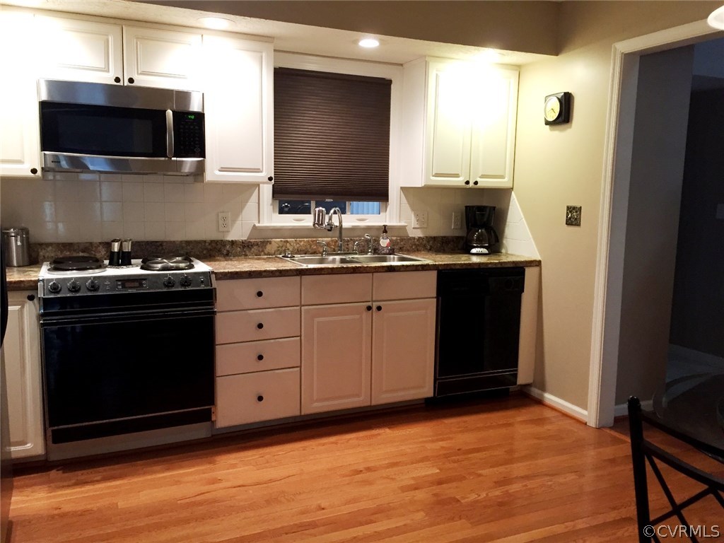 7317 Trailing Rock Road Prince George, VA 23875 - Photo 6 of 17 a kitchen with stainless steel appliances granite countertop a stove a sink and a microwave