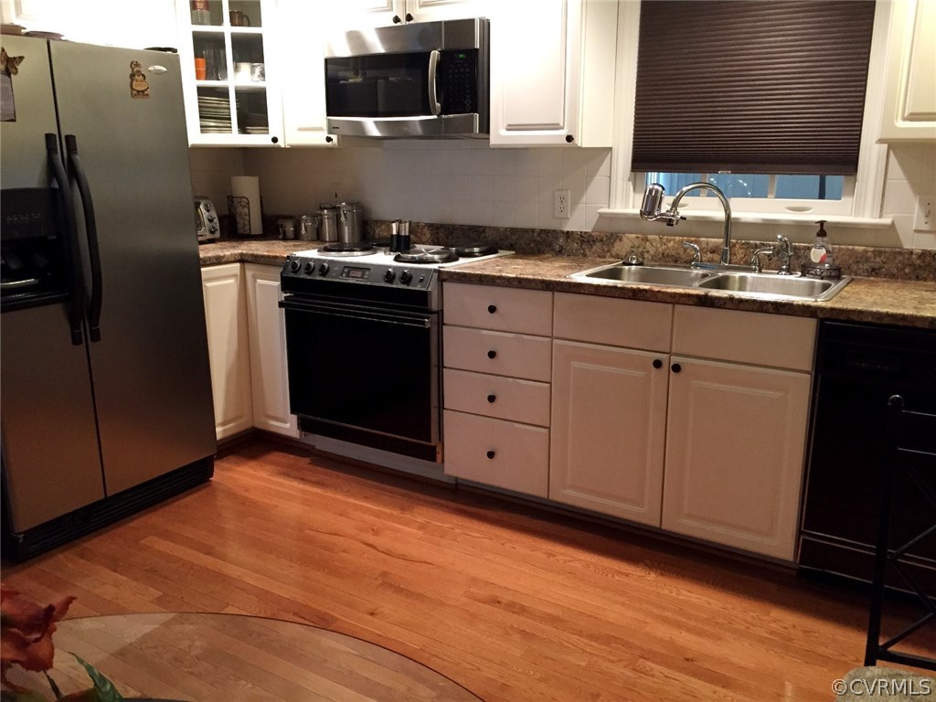 7317 Trailing Rock Road Prince George, VA 23875 - Photo 7 of 17 a kitchen with stainless steel appliances granite countertop a stove a sink and a microwave
