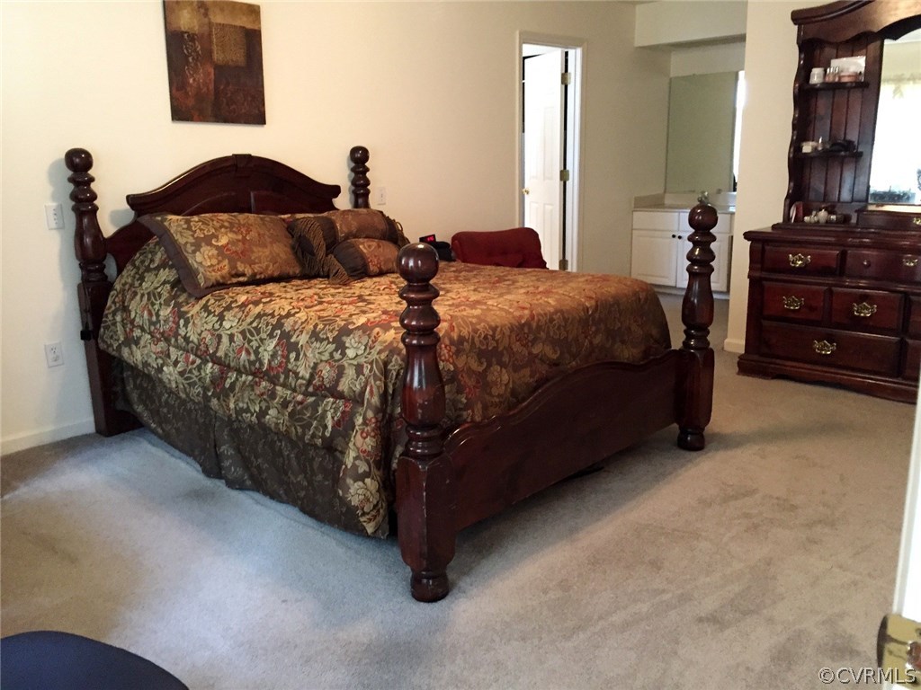 7317 Trailing Rock Road Prince George, VA 23875 - Photo 8 of 17 a bedroom with a bed and a lamp on dresser
