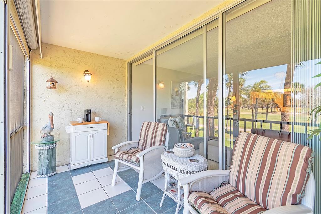 12200 Vonn Road, Unit 2206 Largo, FL 33774 - Photo 24 of 60 a living room with furniture and a floor to ceiling window