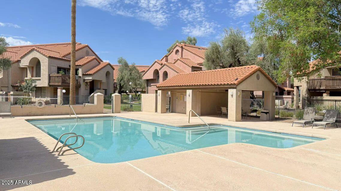 700 East Mesquite Circle, Unit N127 Tempe, AZ 85288 - Photo 13 of 16 a view of a white house with a swimming pool and porch