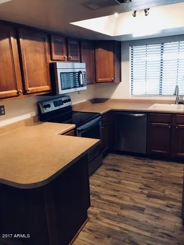 a kitchen with stainless steel appliances granite countertop a sink and a stove