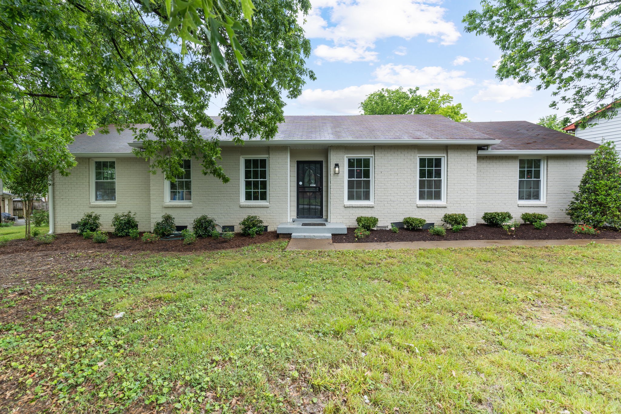 3004 Anderson Road Nashville, TN 37217 - Photo 1 of 28 a front view of house with yard and trees around