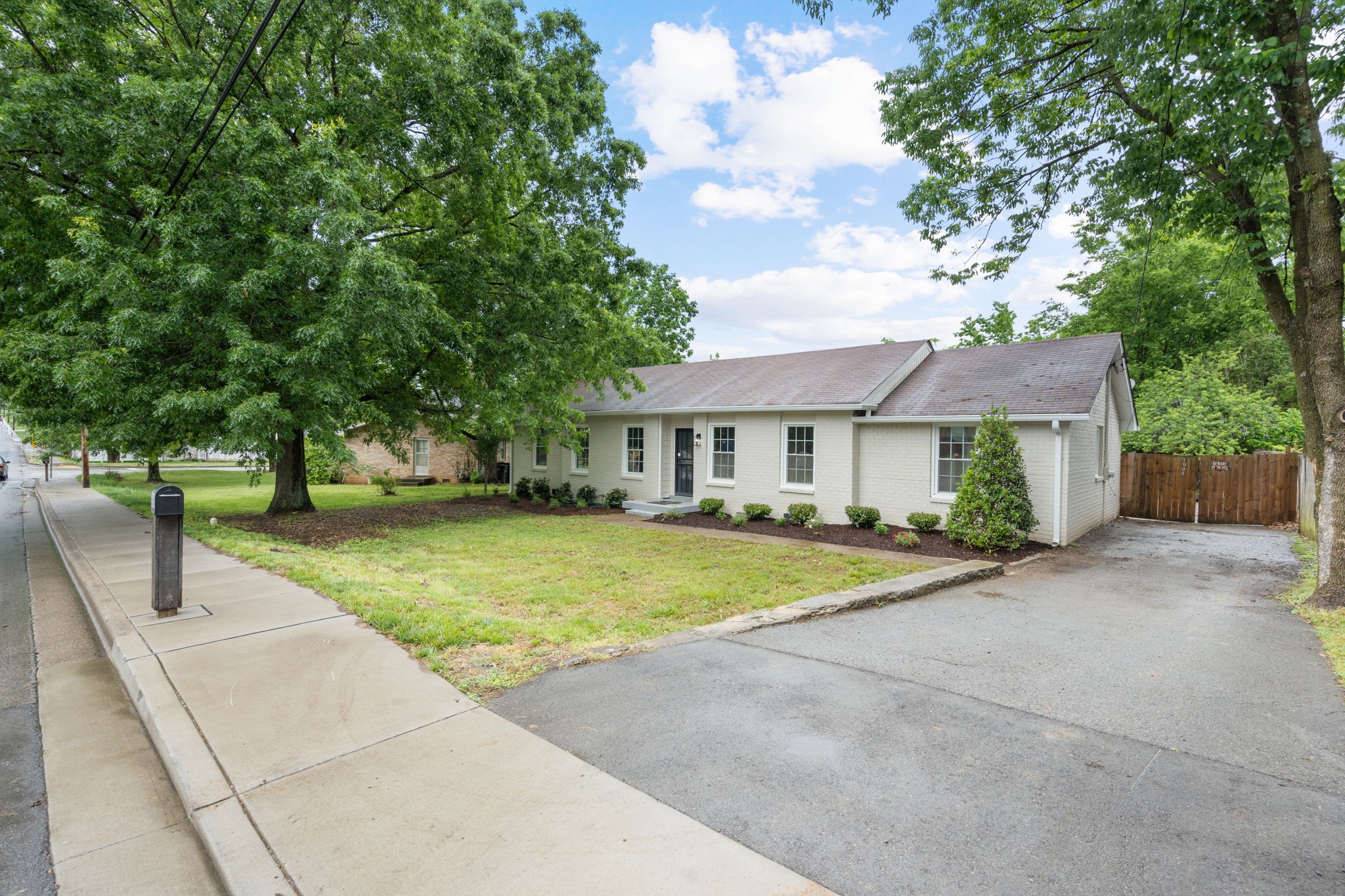 3004 Anderson Road Nashville, TN 37217 - Photo 2 of 28 a front view of a house with a yard and trees