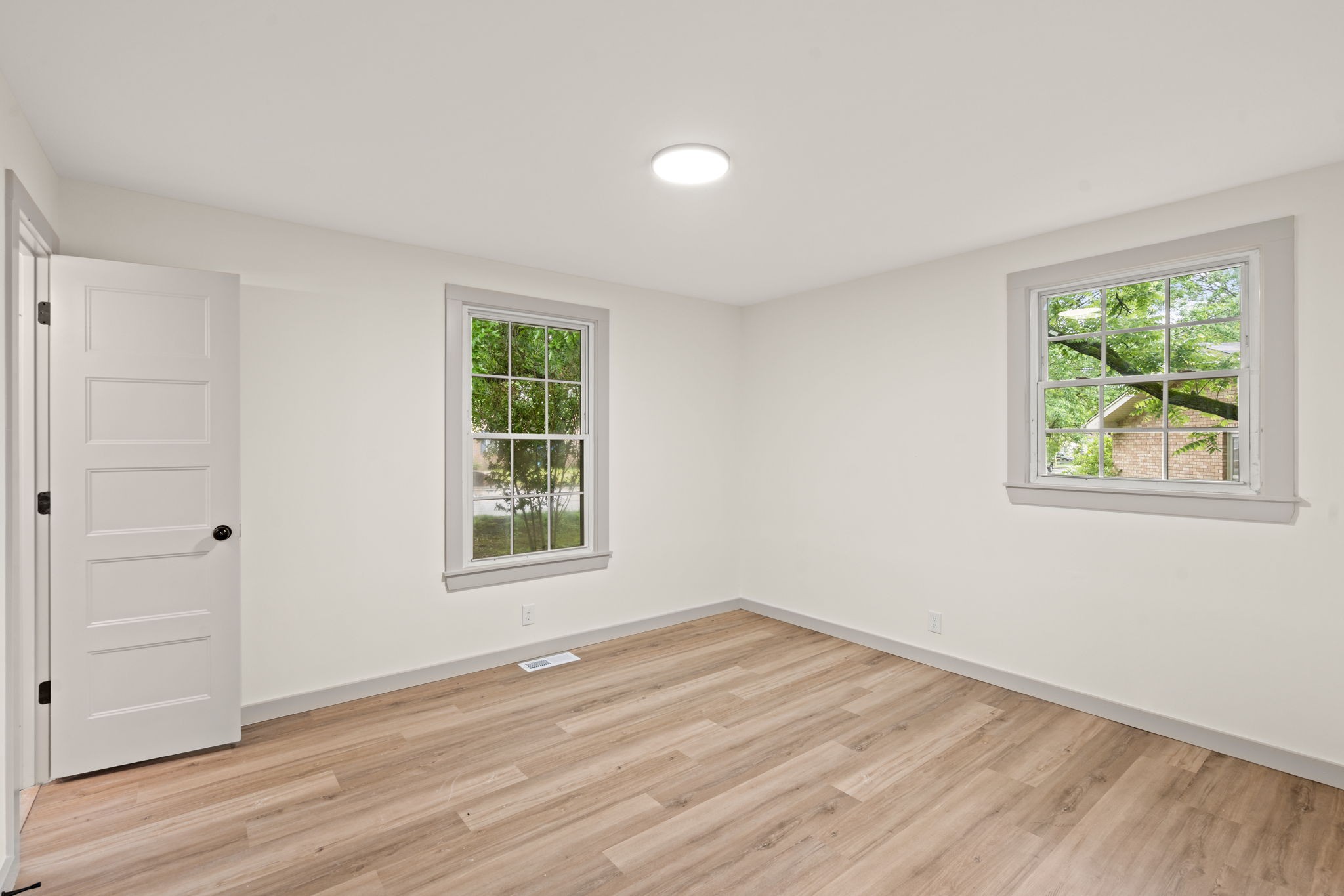 3004 Anderson Road Nashville, TN 37217 - Photo 21 of 28 an empty room with wooden floor and windows