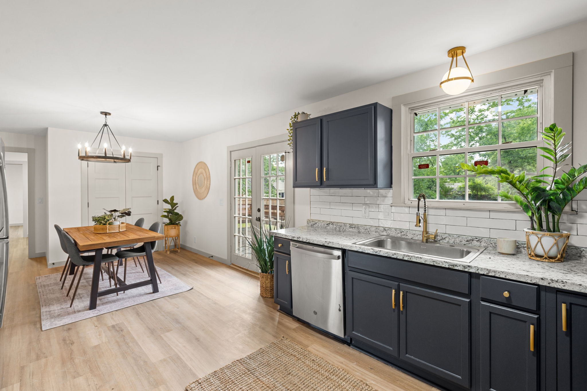 3004 Anderson Road Nashville, TN 37217 - Photo 8 of 28 a kitchen with stainless steel appliances granite countertop sink stove and white cabinets with wooden floor