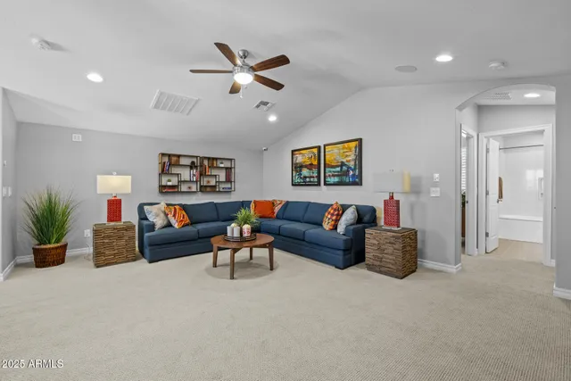 a bedroom with a bed lamp and a window