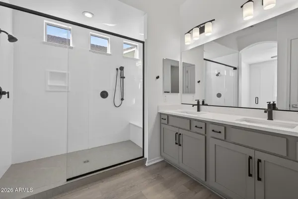 a bathroom with a sink a toilet and mirror