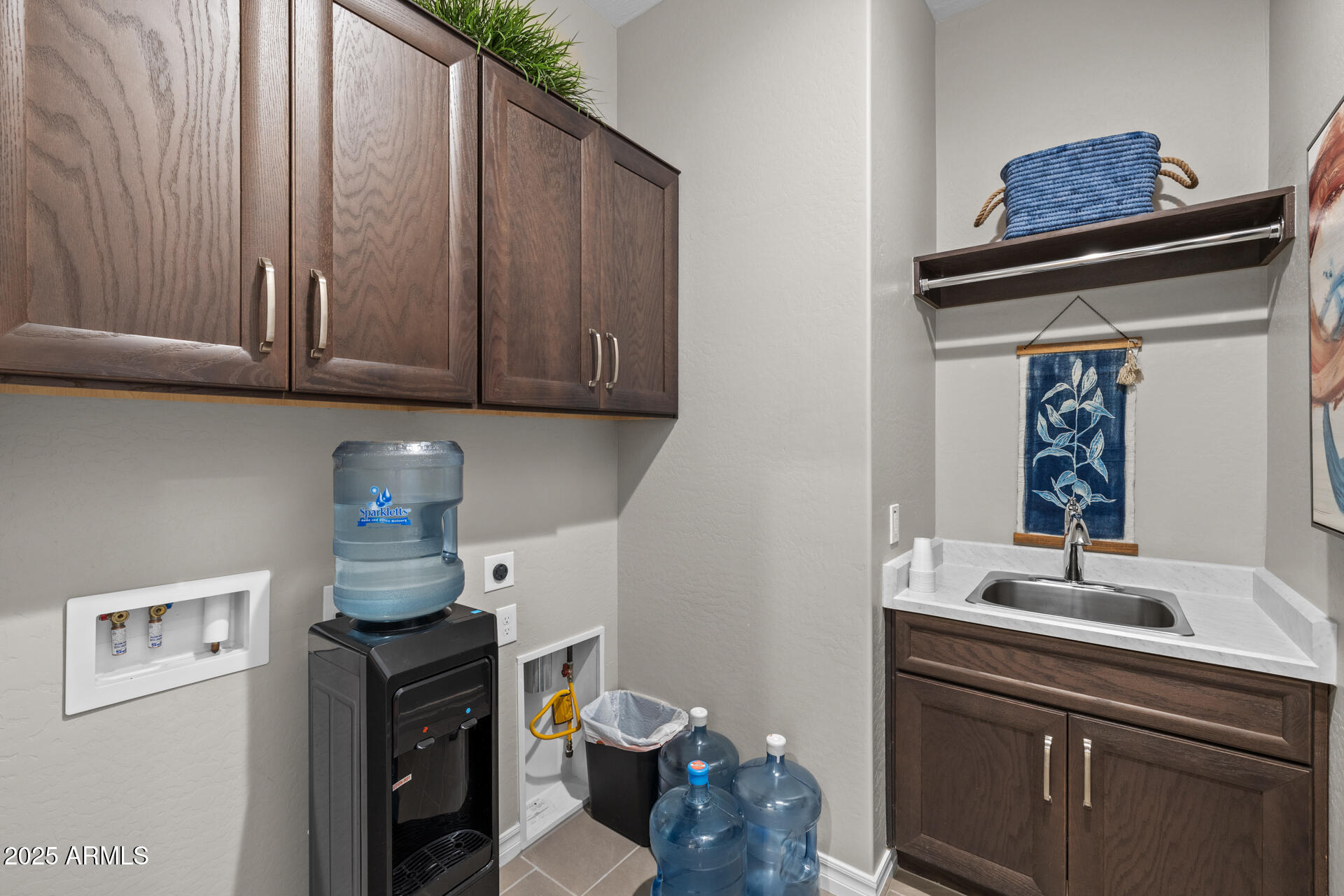 4273 East John Street Gilbert, AZ 85295 - Photo 25 of 29 a kitchen with a sink cabinets and a wooden floor