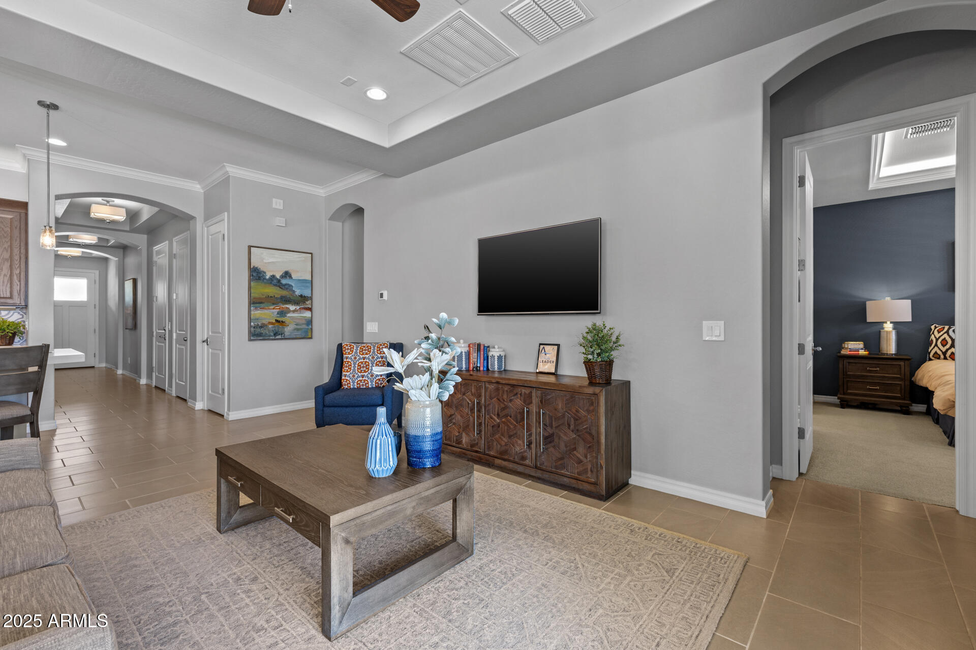 4273 East John Street Gilbert, AZ 85295 - Photo 8 of 29 a living room with furniture and a flat screen tv