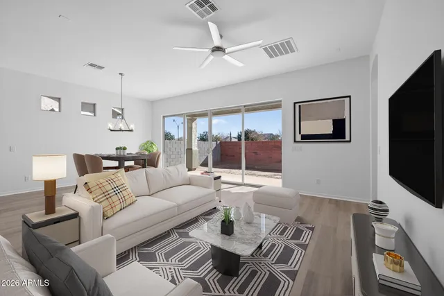 a large white kitchen with wooden floor