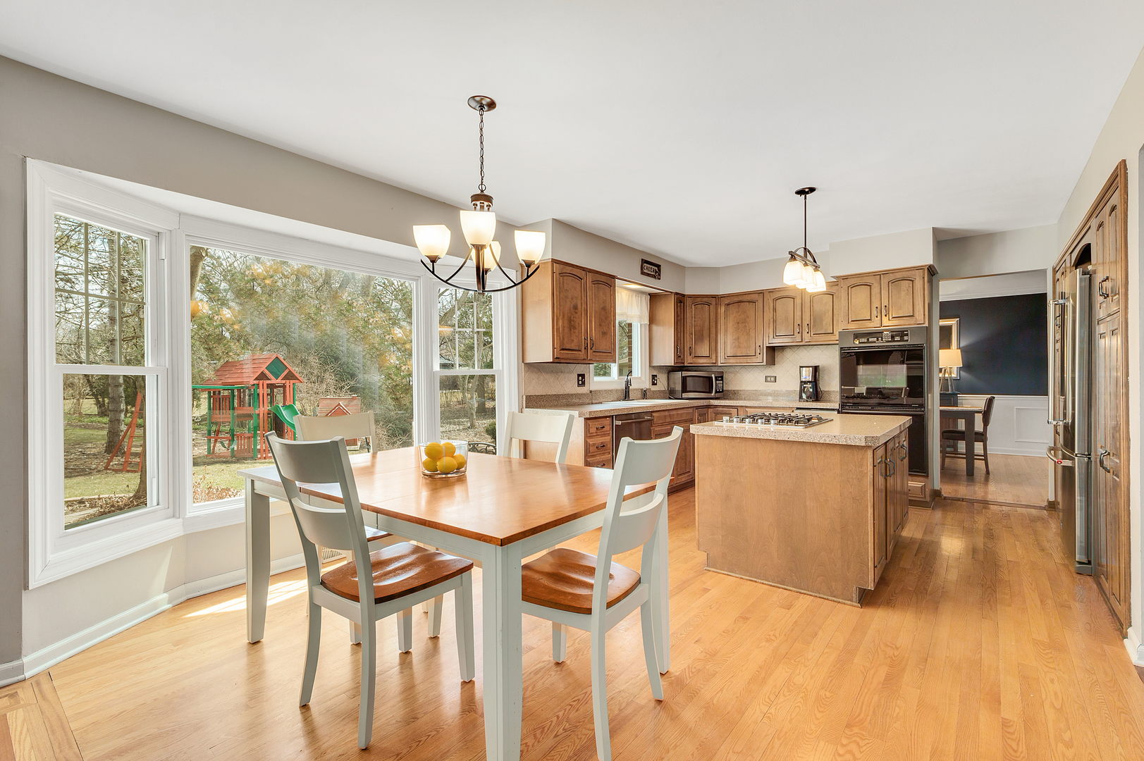 2S567 White Birch Lane Wheaton, IL 60189 - Photo 10 of 31 a view of a dining room and livingroom with furniture large windows a chandelier