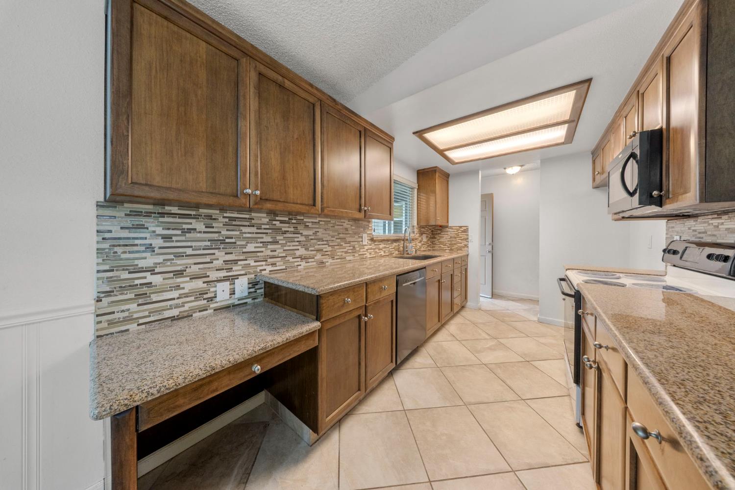 1120 Shasta Avenue Modesto, CA 95358 - Photo 11 of 35 a kitchen with stainless steel appliances granite countertop a sink stove and cabinets