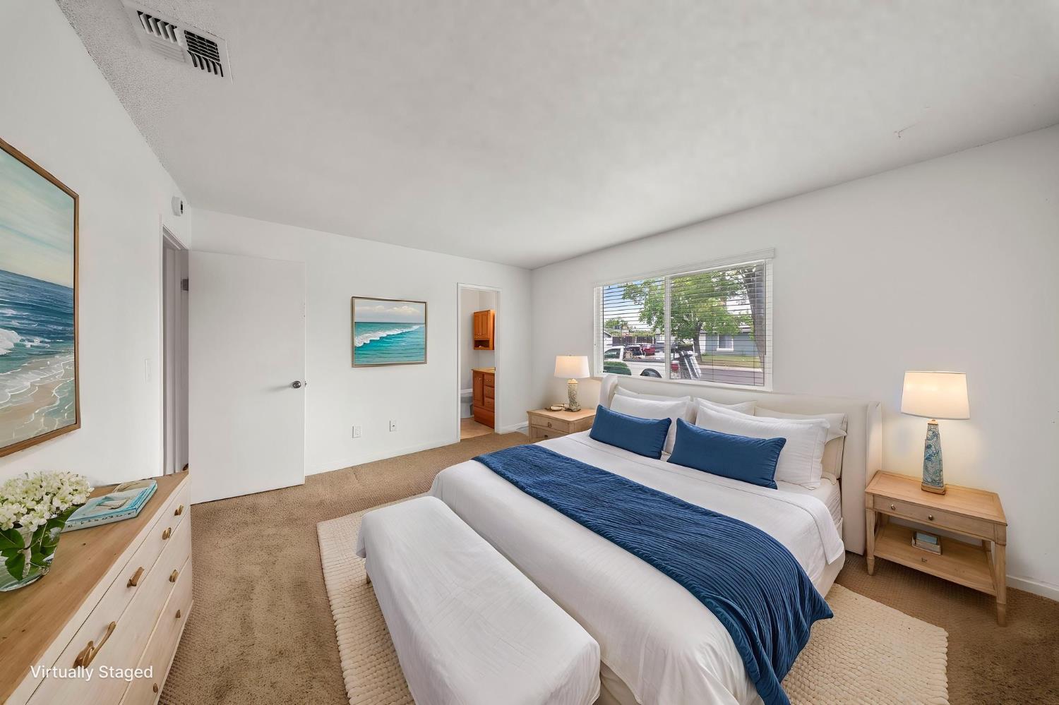 1120 Shasta Avenue Modesto, CA 95358 - Photo 25 of 35 a bedroom with a bed and a painting on the wall