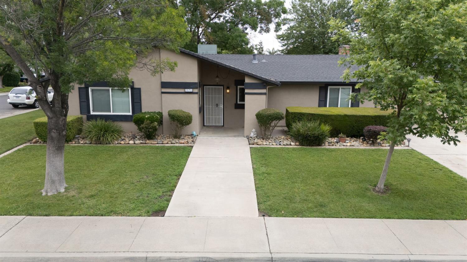1120 Shasta Avenue Modesto, CA 95358 - Photo 33 of 35 a front view of a house with a yard