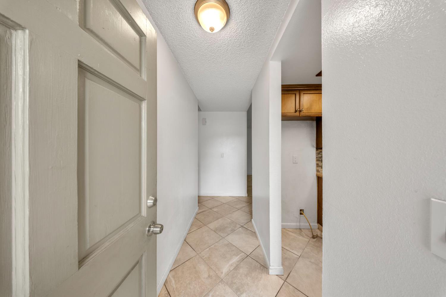 1120 Shasta Avenue Modesto, CA 95358 - Photo 5 of 35 a view of a hallway with wooden floor and a bathroom
