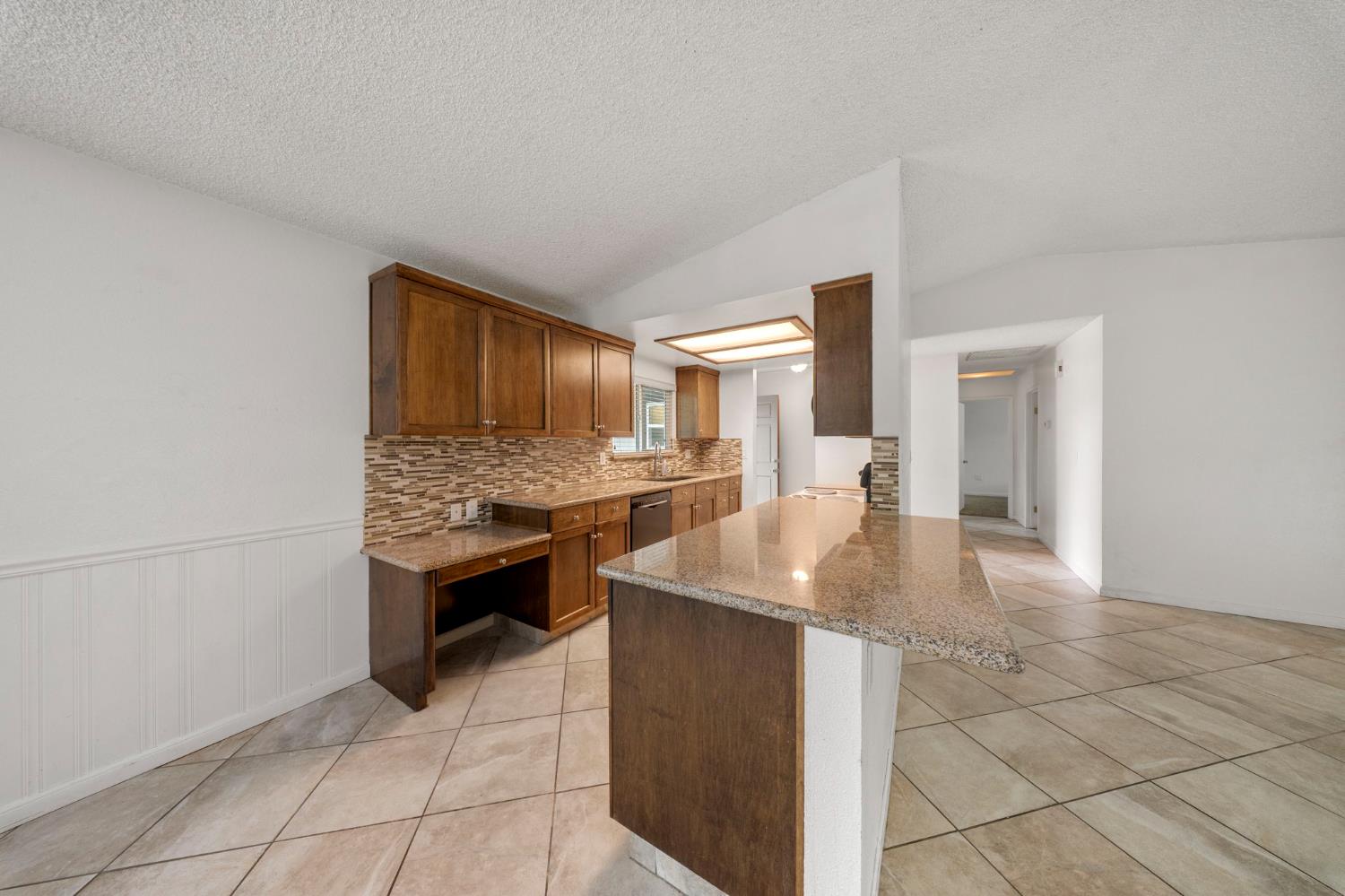 1120 Shasta Avenue Modesto, CA 95358 - Photo 7 of 35 a dining hall with granite countertop a sink and a stove top oven
