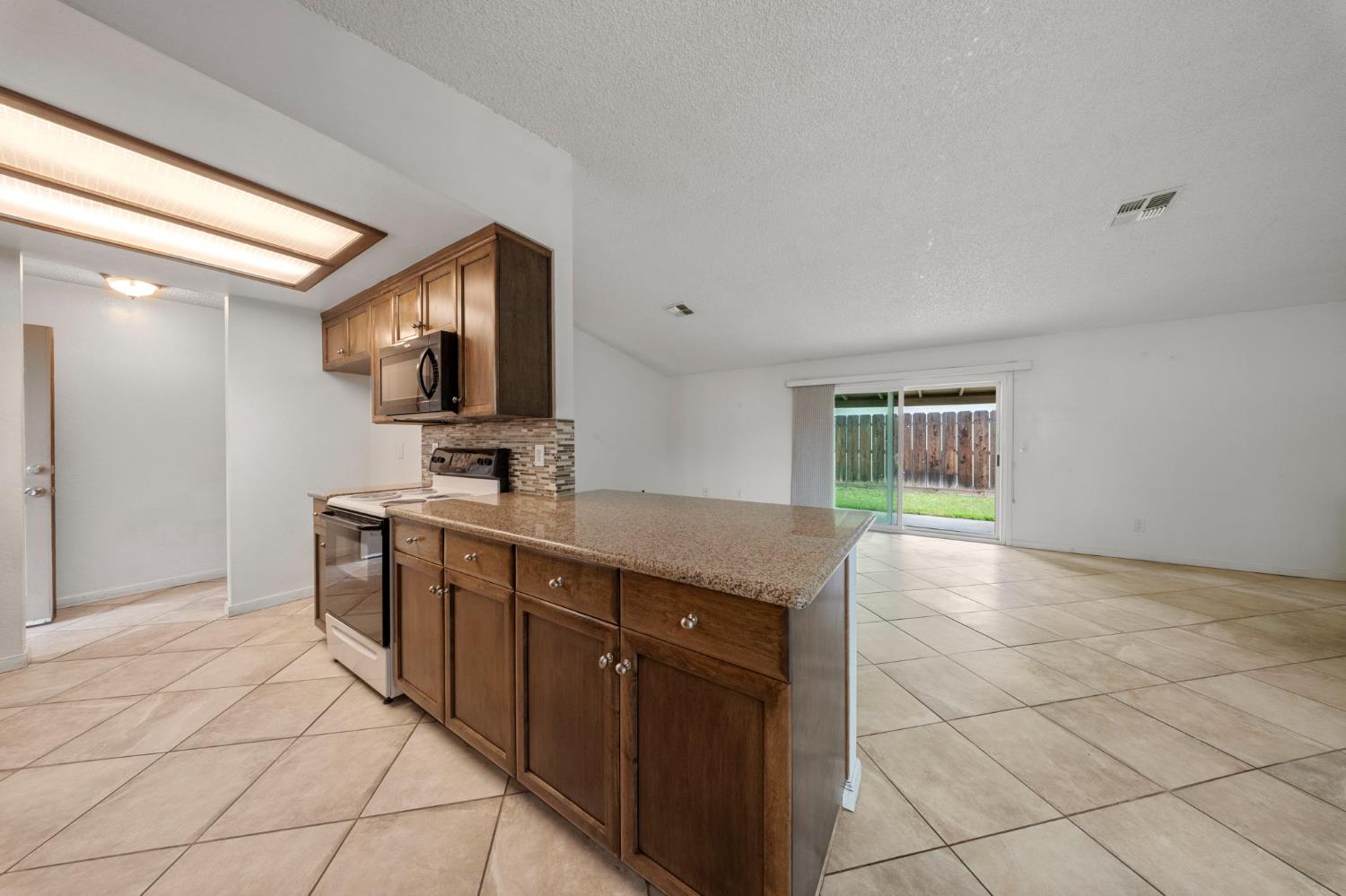 1120 Shasta Avenue Modesto, CA 95358 - Photo 8 of 35 a kitchen with stainless steel appliances granite countertop a sink and a stove top oven