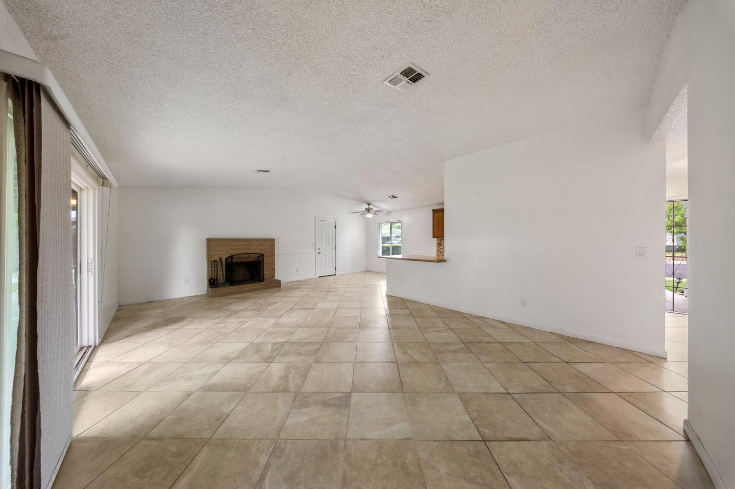 1120 Shasta Avenue Modesto, CA 95358 - Photo 9 of 35 a view of empty room with a fireplace