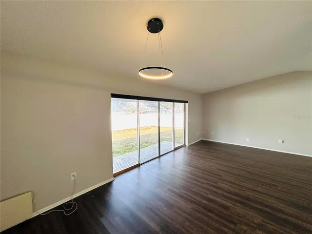 a view of an empty room and wooden floor