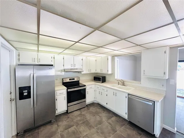 a kitchen with refrigerator and window