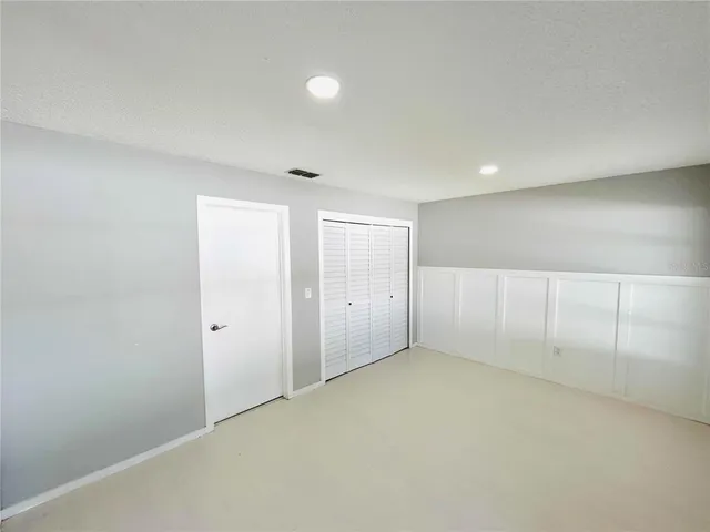 an empty room with closet area