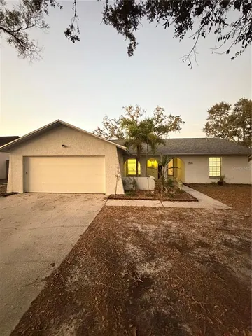 a front view of house with yard and trees