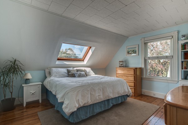 37 Wellman Street, Unit 3 Beverly, MA 01915 - Photo 13 of 21 a bedroom with a bed and glass window