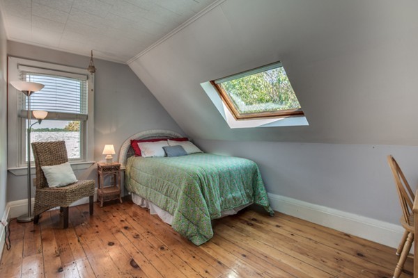 37 Wellman Street, Unit 3 Beverly, MA 01915 - Photo 15 of 21 a bedroom with a bed and windows