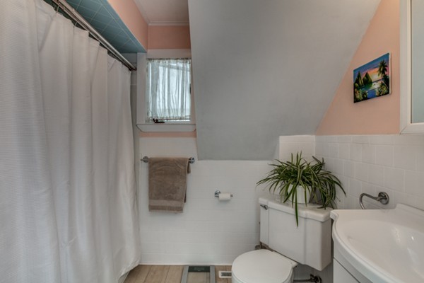 37 Wellman Street, Unit 3 Beverly, MA 01915 - Photo 17 of 21 a bathroom with a toilet a sink and tub