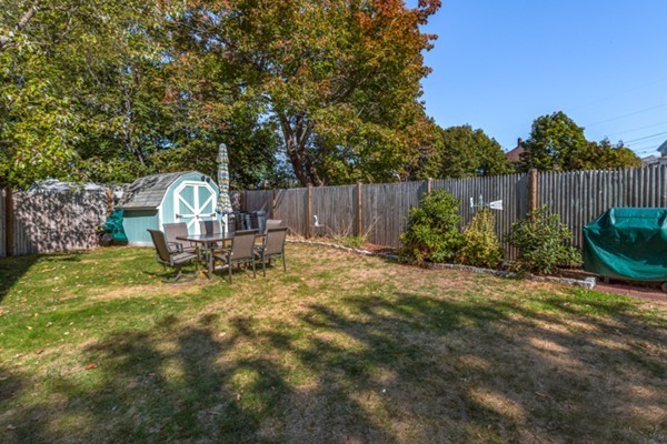 37 Wellman Street, Unit 3 Beverly, MA 01915 - Photo 19 of 21 a view of a backyard with plants and wooden fence