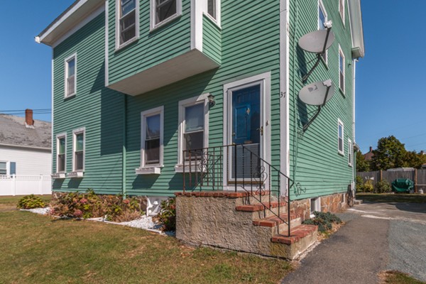 37 Wellman Street, Unit 3 Beverly, MA 01915 - Photo 2 of 21 a small garden in the backyard of a house