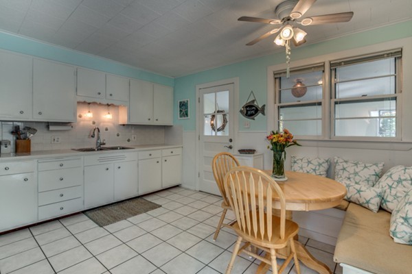 37 Wellman Street, Unit 3 Beverly, MA 01915 - Photo 6 of 21 a kitchen with granite countertop white cabinets and stainless steel appliances