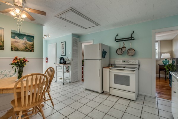 37 Wellman Street, Unit 3 Beverly, MA 01915 - Photo 8 of 21 a kitchen with stainless steel appliances a stove a chimney a sink and cabinets