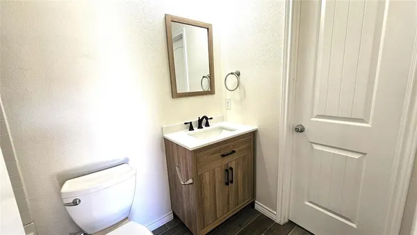 a white toilet sitting next to a bath tub