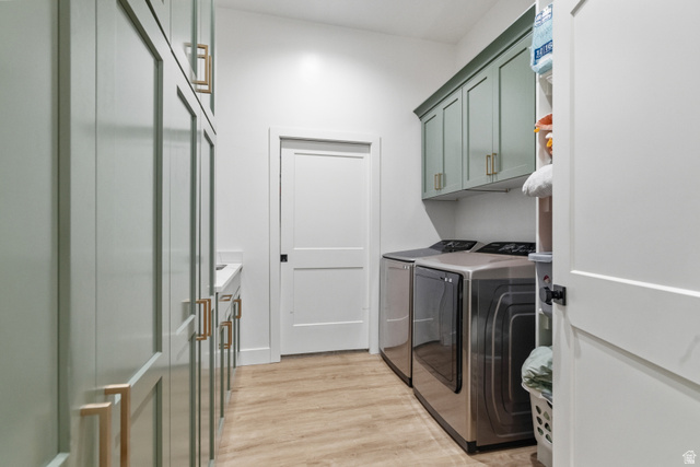 2013 South 100 West Perry, UT 84302 - Photo 28 of 49 Laundry room featuring light green cabinetry with gold-toned hardware, wood-finish flooring, and white walls