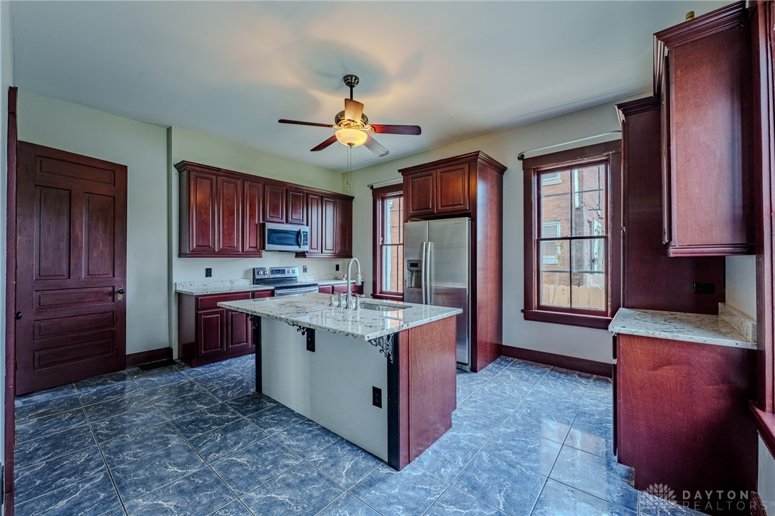 308 Yankee Road Middletown, OH 45044 - Photo 18 of 47 This spacious kitchen features ample cabinetry, an inviting island, and modern appliances perfect for daily living.