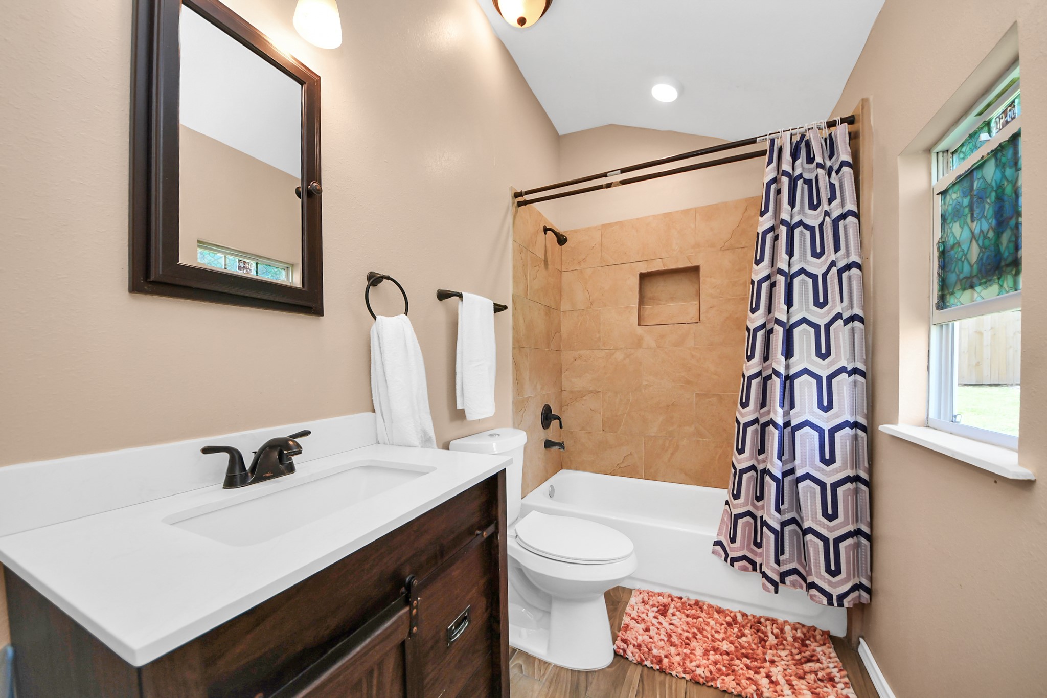 14961 Lamar Road Willis, TX 77378 - Photo 25 of 31 Full bathroom with tub/shower combo featuring tile surround and modern fixtures.