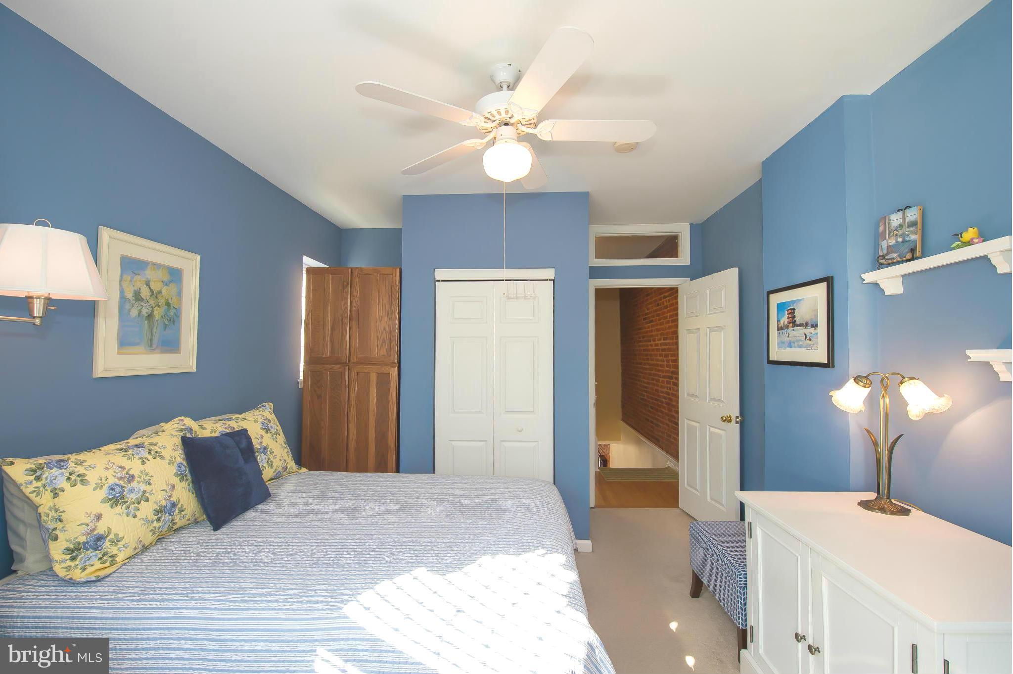 819 South Potomac Street Baltimore, MD 21224 - Photo 14 of 30 a bedroom with a large bed and a chandelier